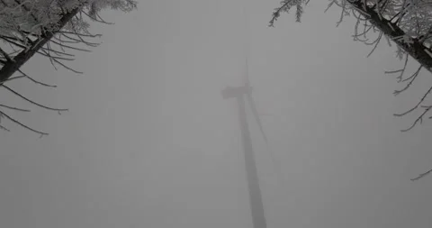 A wind turbine in the fog in winter Stock Footage
