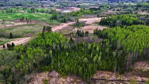 Wind turbine foundation construction and access road development in a rural area Stock Footage 341383683