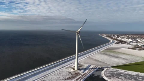 Wind turbine generating clean energy in winter landscape Видео 333672984