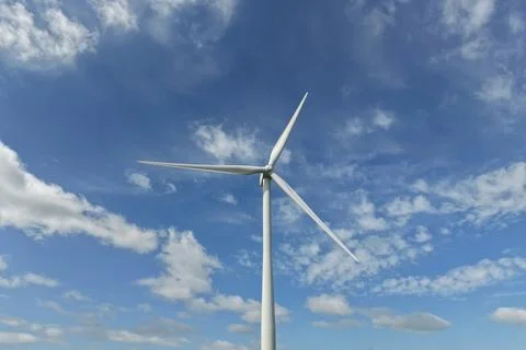 Wind turbine generating clean renewable energy under blue sky Stock-Fotos