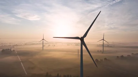 Wind turbine generating renewable energy at sunrise Stock Footage 288239261