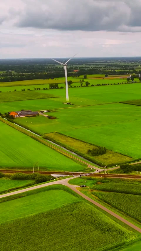 Wind turbine generating renewable energy in green countryside Stock Footage 327111476