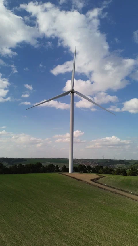 Wind Turbine Generating Renewable Energy Above Cereal Field in Rural Landscape Stock Footage 331119951