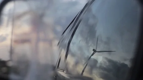 Wind turbine gets reflected in car window Stock Footage 77029662