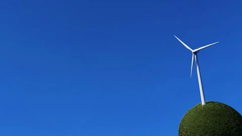 Wind turbine on grass sphere shape with clear sky Stock Footage 225658793