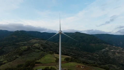 Wind turbine in a hilly landscape Stock Footage 260313845