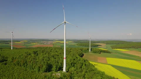 Wind turbine on a hilly landscape Video stock 286797652