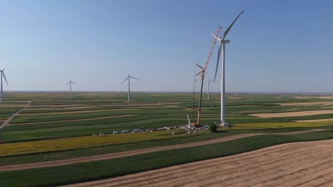 Wind turbine installation using a large construction crane. The assembly process Stock Footage 312725881