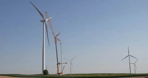 Wind turbine installation using a large construction crane. The assembly process Stock Footage 312731290