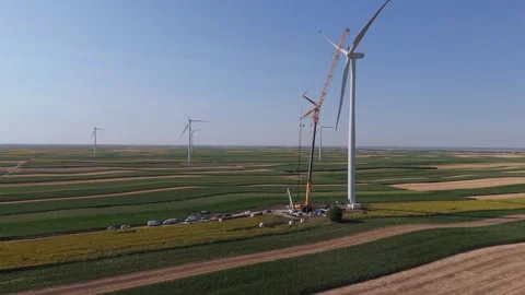 Wind turbine installation using a large construction crane. The assembly process Stock Footage 312731728