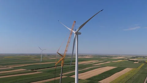 Wind turbine installation using a large construction crane. The assembly process Stock Footage 312732550