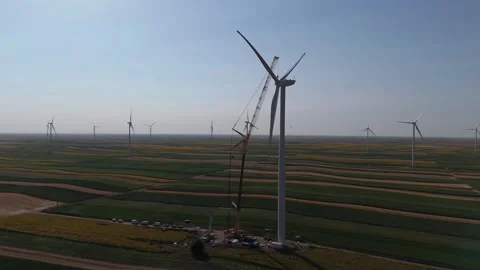 Wind turbine installation using a large construction crane. The assembly process Stock Footage 312732926