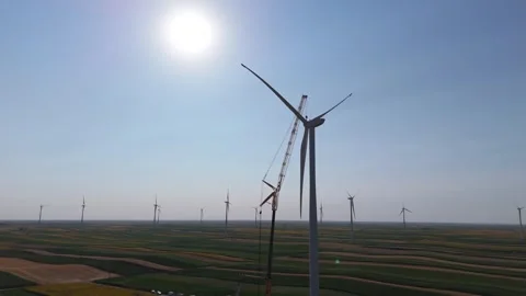 Wind turbine installation using a large construction crane. The assembly process Stock Footage 312733594