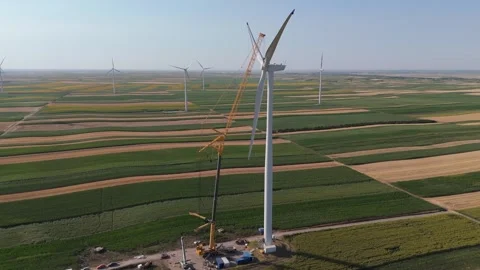 Wind turbine installation using a large construction crane. The assembly process Stock Footage 312735988