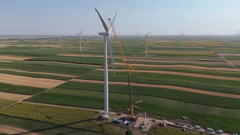Wind turbine installation using a large construction crane. The assembly process Stock Footage 312736416