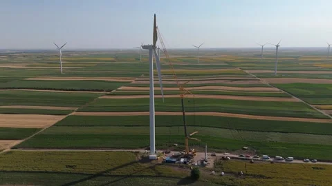 Wind turbine installation using a large construction crane. The assembly process Stock Footage 312736885