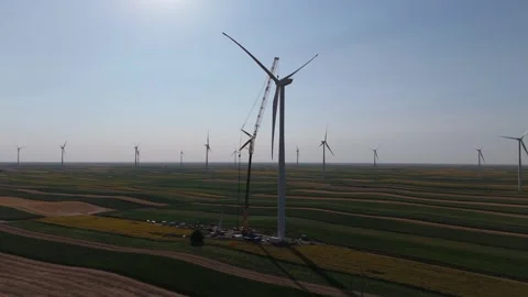 Wind turbine installation using a large construction crane. The assembly process Stock Footage 312737073