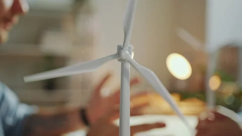 Wind Turbine Model on Office Table during Business Meeting of Two Engineers Stock Footage 265936046