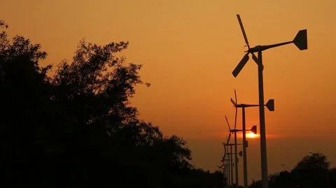 Wind turbine power generator at twilight in Bang Pu Recreational Retreat Center Stock Footage 64008058