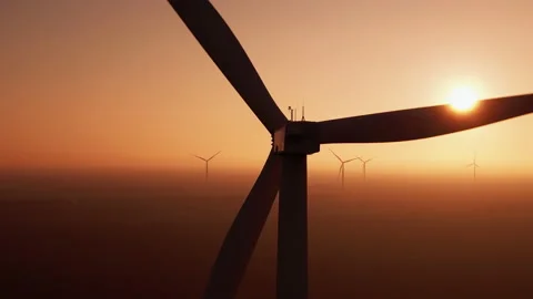 Wind turbine with powerful propeller rotates at sunset Stock Footage 166034656
