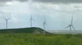 Wind turbine propellers spinning in wind, windmills in beautiful green field 4k or 4k+ Resolution