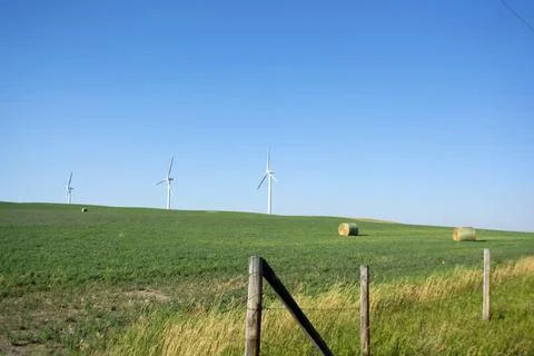 Wind turbine providing wind generated energy - sustainable energy on farm Stock Photos