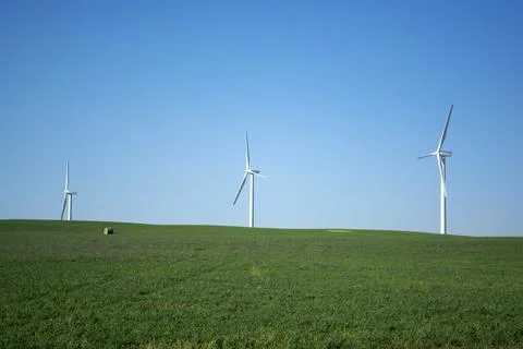 Wind turbine providing wind generated energy - sustainable energy on farm Stock Photos