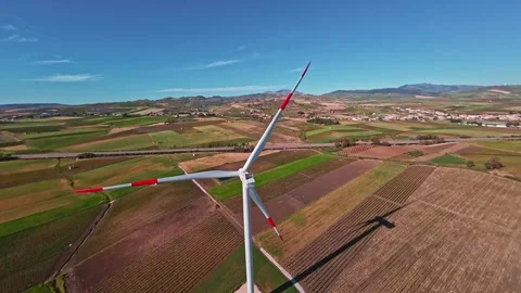 Wind turbine rotating with an aerial camera, green fields, Sicily, 4K Stock Footage 288652222