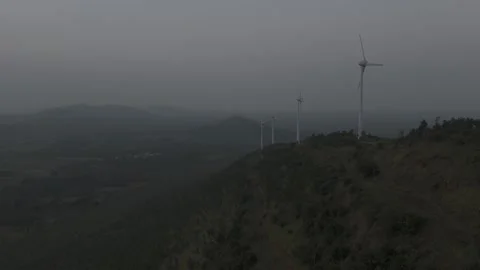 Wind turbine rotating against a cloudy sky Stock Footage 302265545