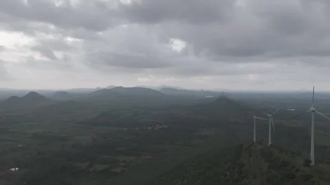 Wind turbine rotating against a cloudy sky Stock Footage 302265567