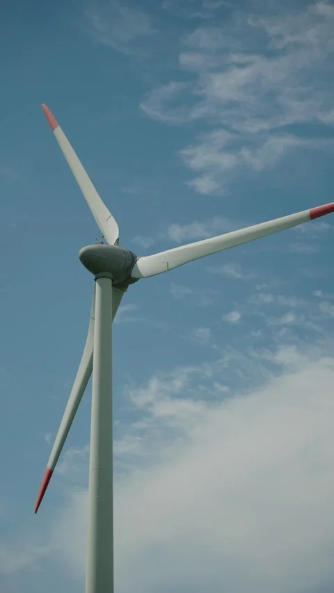 Wind turbine with rotating blades showcasing renewable energy technology Stock Footage 313333919