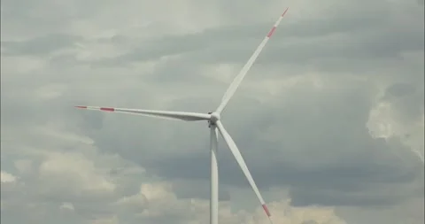 Wind turbine rotating blades under cloudy sky Stock Footage 304563052