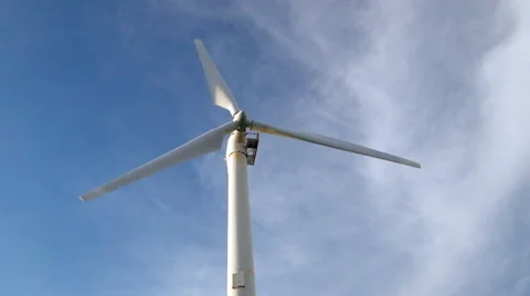 Wind turbine rotating over blue sky generating green energy Stock Footage 46020120