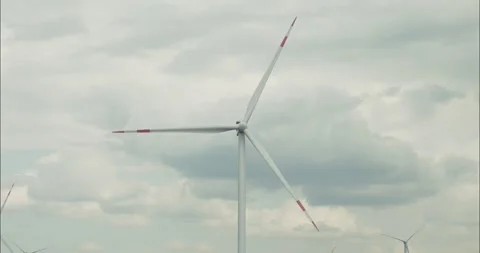 Wind turbine rotating under cloudy sky Stock Footage 304401141