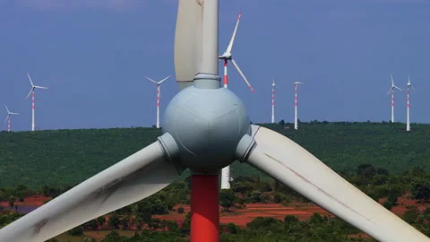 Wind Turbine Rotor Close Up with Wind Farm in Background Stock Footage 335800669