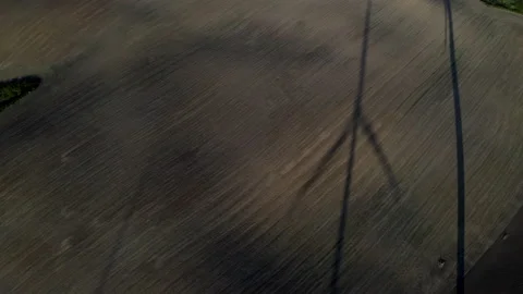 Wind Turbine Shadow On Open Grass Field Generating Green Energy Stock Footage 138442755