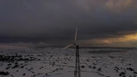 Wind turbine in snow by sunset Stock Footage 149047907
