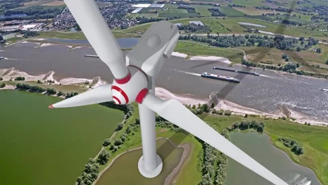 Wind turbine spinning with a river in the background Stock Footage 231489022