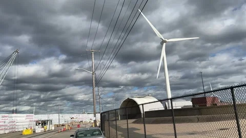 Wind Turbine Spinning Under Cloudy Sky Stock Footage 317632273
