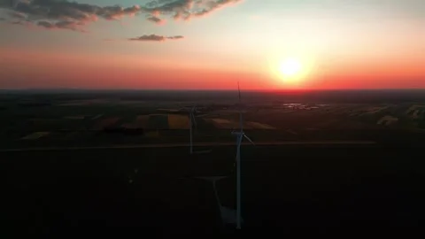 Wind turbine at sunset in bright red Stock Footage 243713319