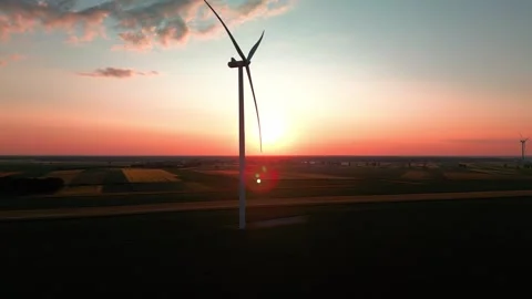 Wind turbine at sunset in bright red Stock Footage 243713362
