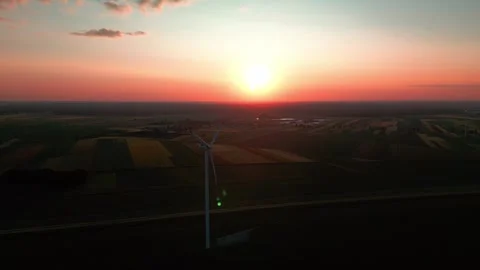 Wind turbine at sunset in bright red Stock Footage 243713846
