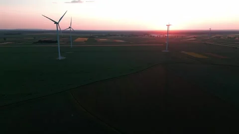 Wind turbine at sunset in bright red Stock Footage 243720119