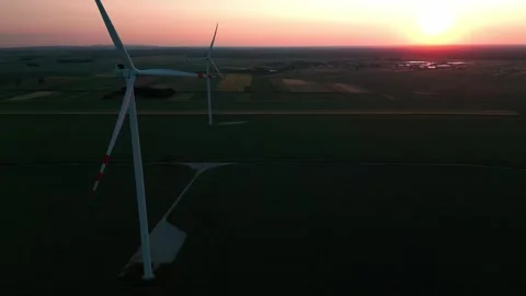Wind turbine at sunset in bright red Stock Footage 243750671