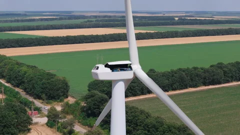 Wind turbine technician at work during maintenance on top of nacelle Stock Footage 311694464