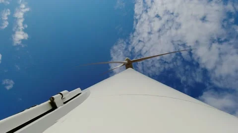 Wind turbine windmill with blades producing clean alternative renewable energy Stock Footage 163602929