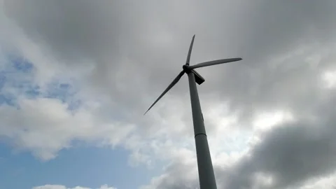 Wind turbine windmill with blades producing clean alternative renewable energy Stock Footage 163603182