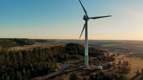 A wind turbine working on a sunset background. Renewable energy concept. Stock Footage 99288708