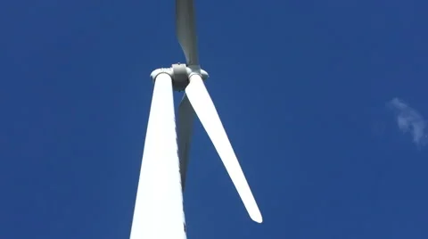 A wind turbine works in the wind under blue sky Video stock 67890752