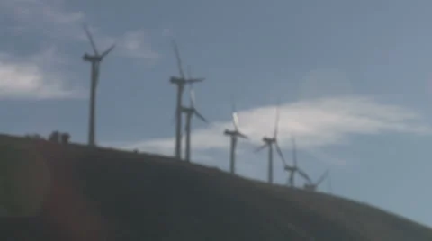 Wind turbine w/rack focus &amp; lens flare Stock Footage 1039682